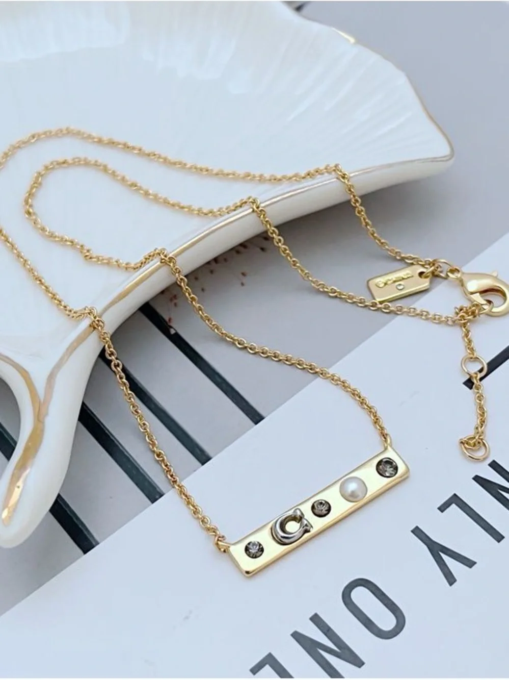 Coach Gold-Tone Bar Necklace with Crystal and Pearl Accents - Picture 3 of 5